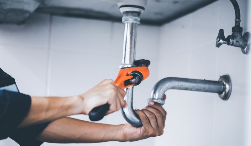 Plumber Using a Wrench